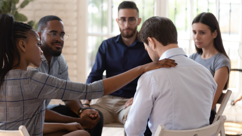 Man Being Comforted during Group Counseling