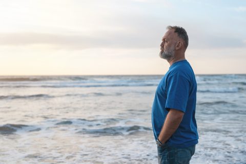 Man Standing on Beach While Thinking