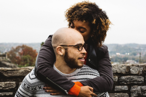 Man and Woman Embracing by a Stone Wall