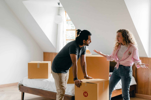 Couple Arguing While Packing Boxes